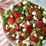Overhead view of a salad with strawberries, goat cheese, and pecans