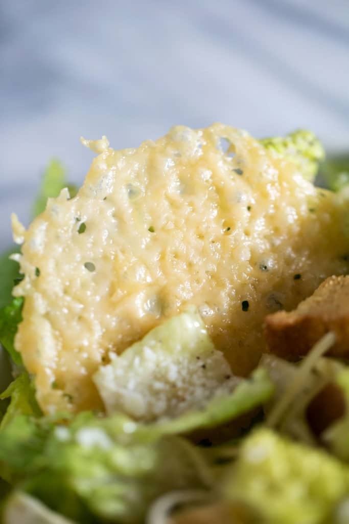 Up close view of a parmesan crisp in a salad