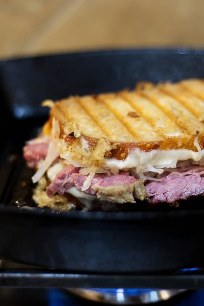 A toasted reuben sandwich in a pan