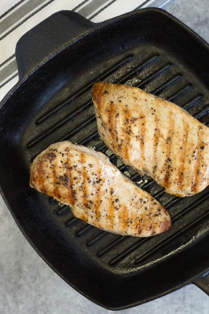Grill pan with cooked chicken breasts