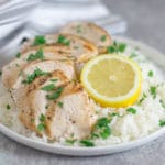 plate of chicken and rice with lemon and herbs