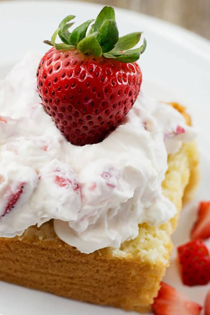 Pound cake topped with whipped cream and a strawberry