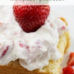 A piece of pound cake topped with strawberries and whipped cream