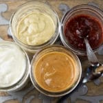 Overhead view of 4 mason jars with different condiments