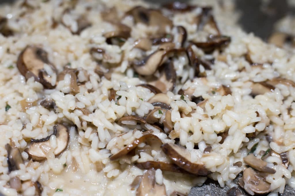 Up close view of cooked rice and cremini mushrooms