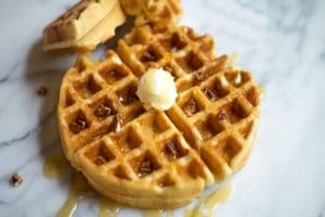 Belgian waffle topped with mascarpone cheese and maple syrup