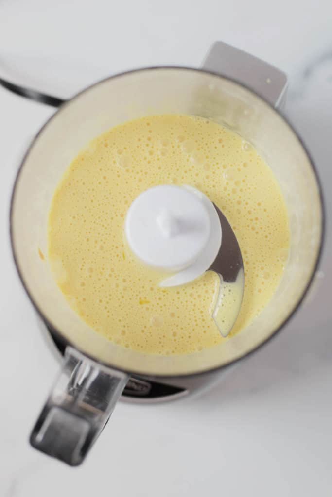 Overhead view of a food processor filled with hollandaise sauce