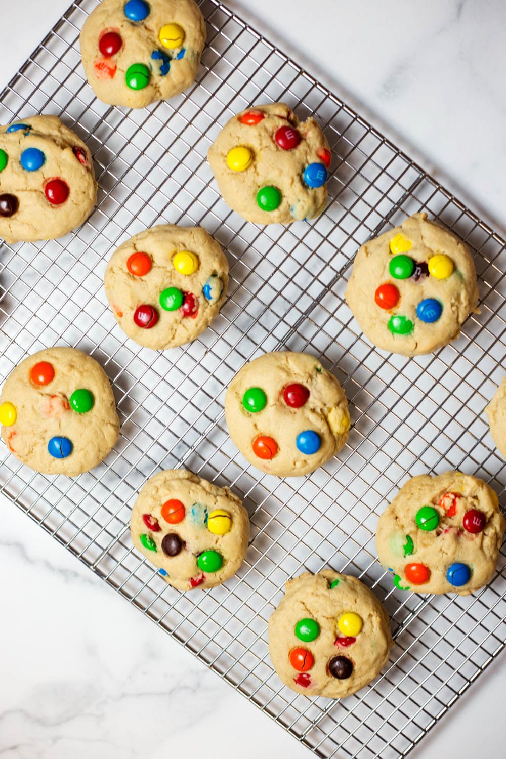 A wire baking rack topped with M&M cookies