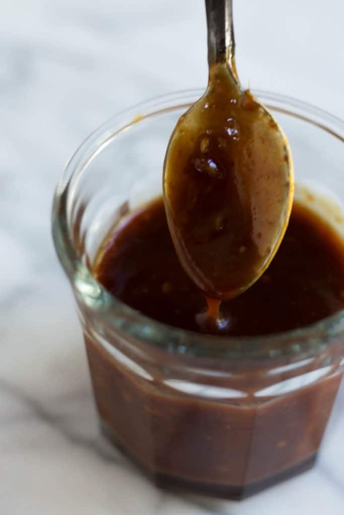 Spoon dipped in miso ginger sauce