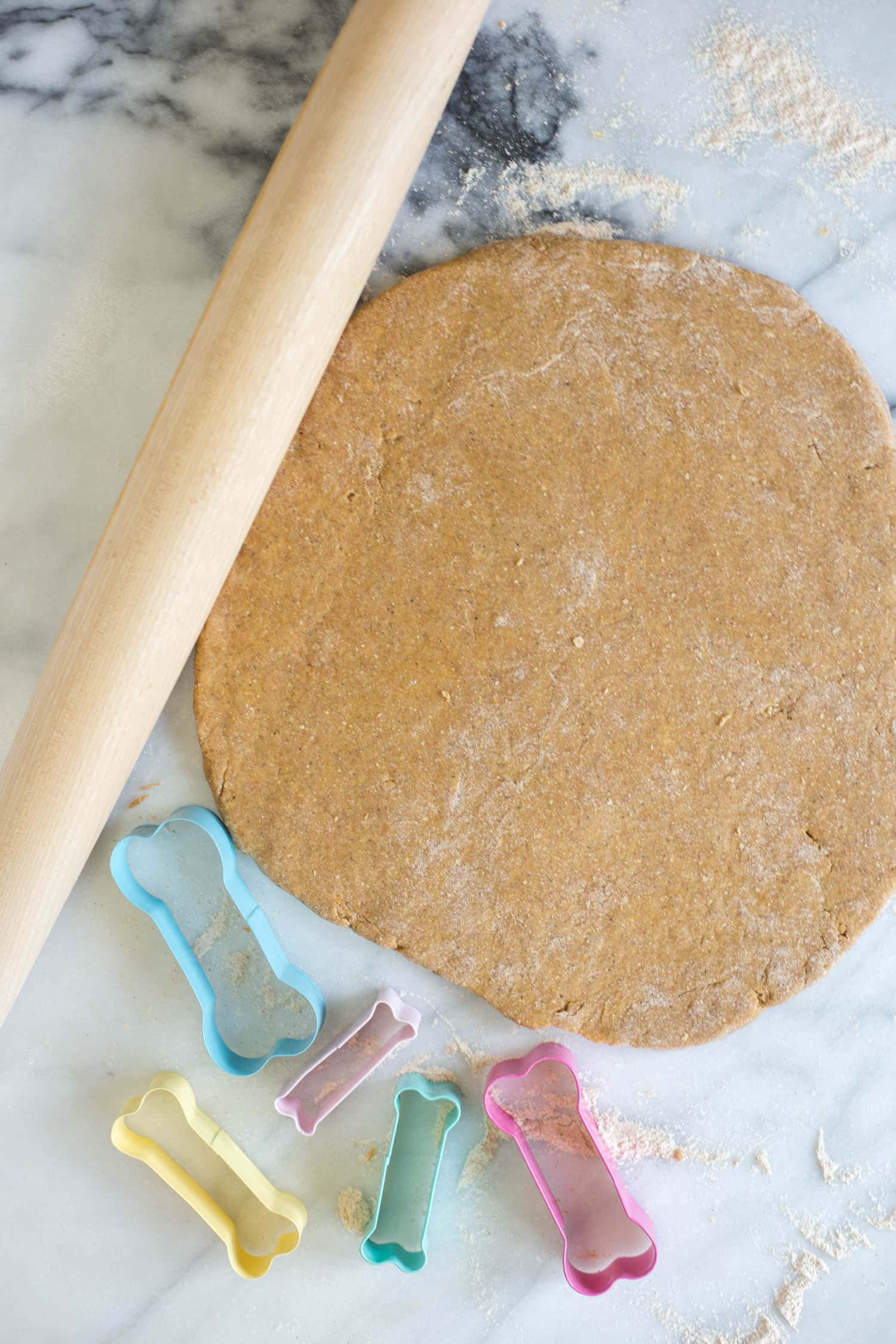 Dog biscuit dough rolled out on cutting board
