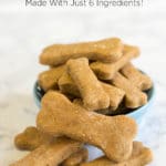A blue dish filled with homemade dog biscuits shaped like bones