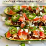 Zucchini stuffed with chorizo, cheese, diced tomatoes, sliced jalapenos, and crumbled white cheese