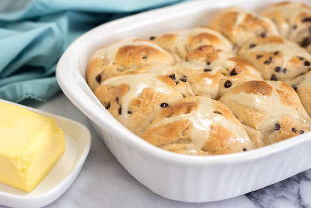 White baking dish with baked hot cross buns
