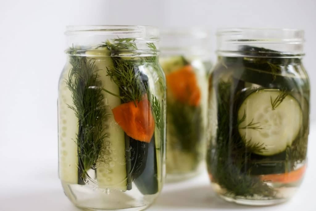 3 mason jars of pickles with dill and habanero peppers