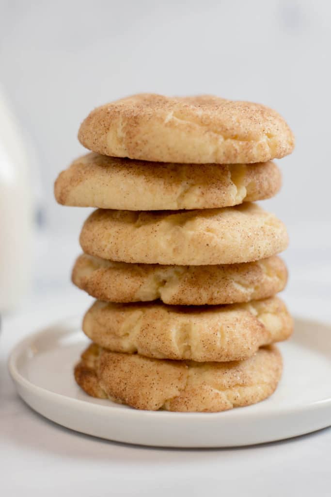 A stack of 6 snickerdoodle cookies on a small round white plate