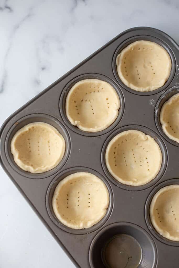 Unbaked pie crust pressed into muffin tin 