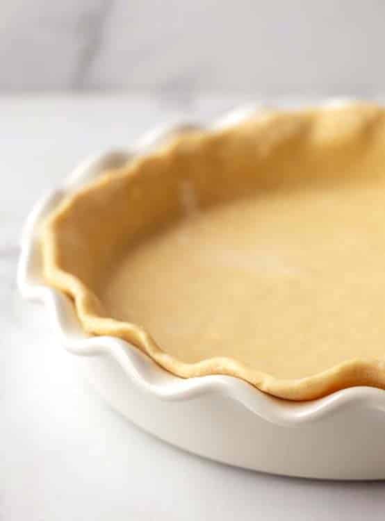 White pie dish with uncooked pie crust